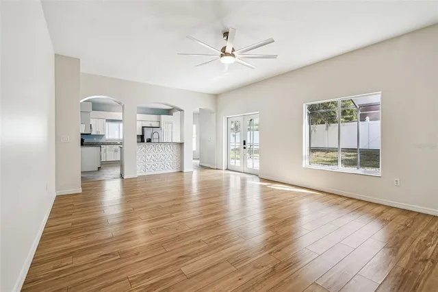 a view of a kitchen with furniture and wooden floor