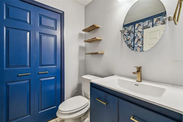 a bathroom with a sink a toilet and vanity