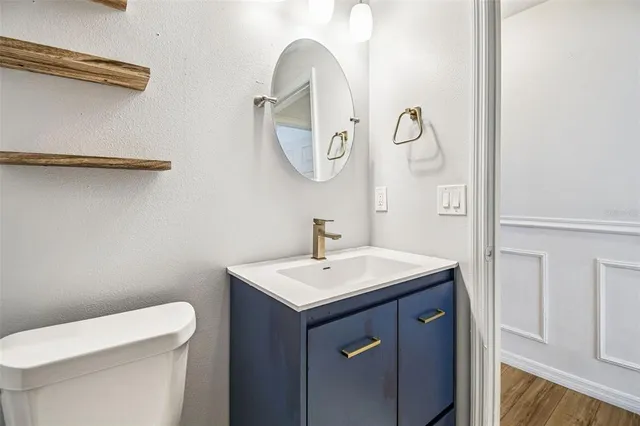 a bathroom with a toilet sink and mirror