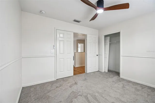 an empty room with closet and entryway