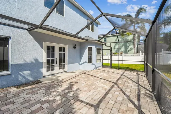 front view of house with a street and potted plants