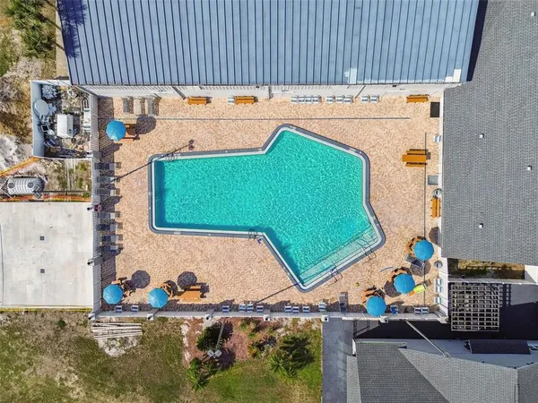 a view of backyard with swimming pool and green space