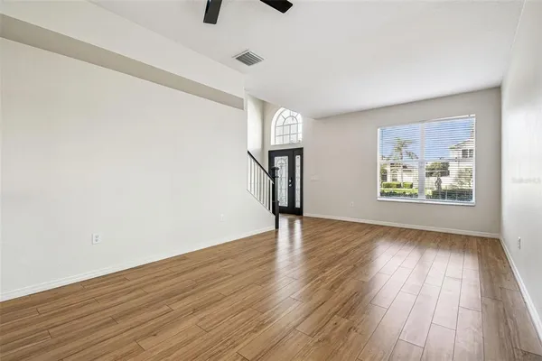 wooden floor in an empty room with a window