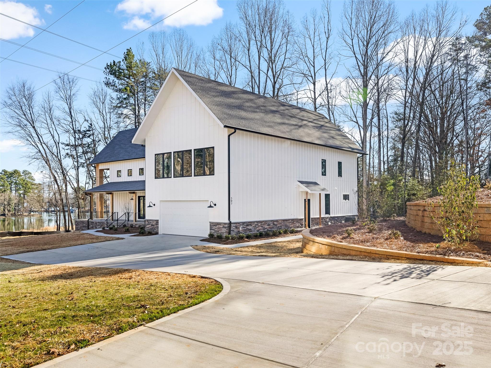 a view of a house with snow on the side of the road