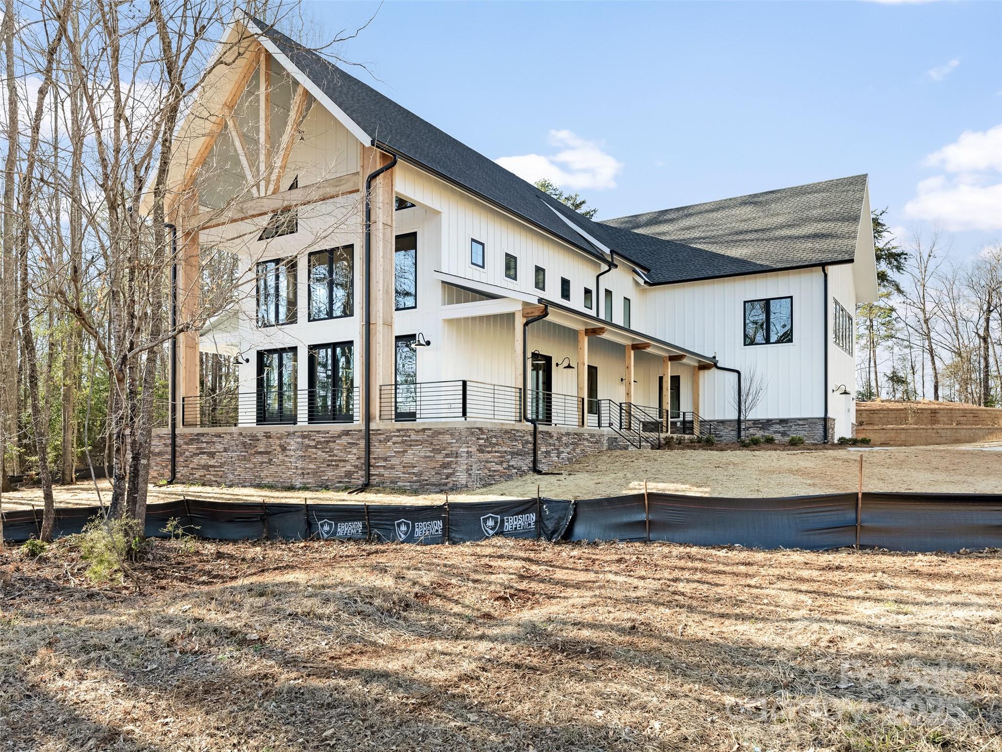 597 Evergreen Road Clover, SC 29710 - Photo 3 of 23 a view of a white house next to a yard with large trees