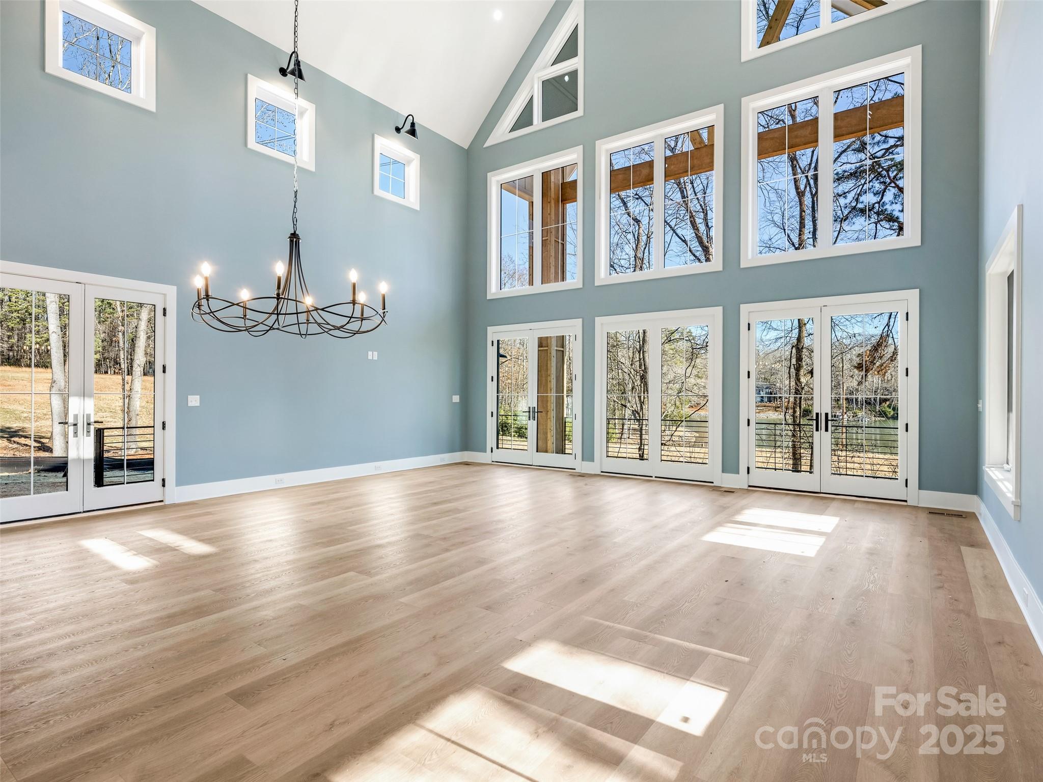 597 Evergreen Road Clover, SC 29710 - Photo 8 of 23 a view of an empty room with wooden floor and a large window
