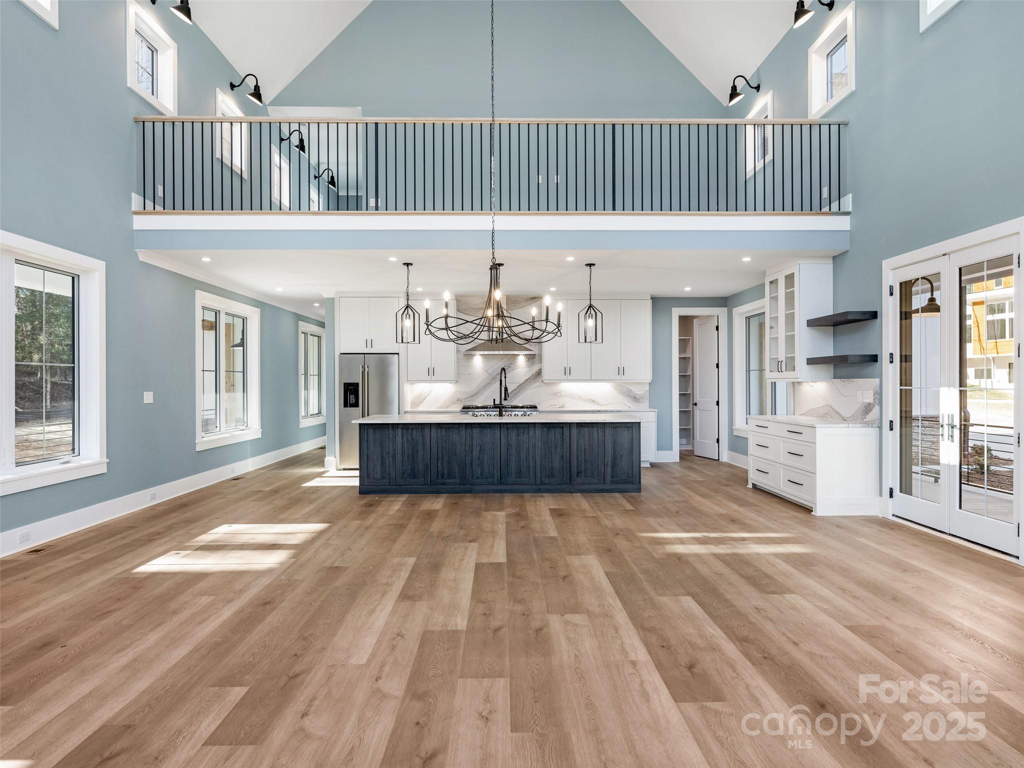 597 Evergreen Road Clover, SC 29710 - Photo 9 of 23 a view of a living room and kitchen with furniture wooden floor and a large window