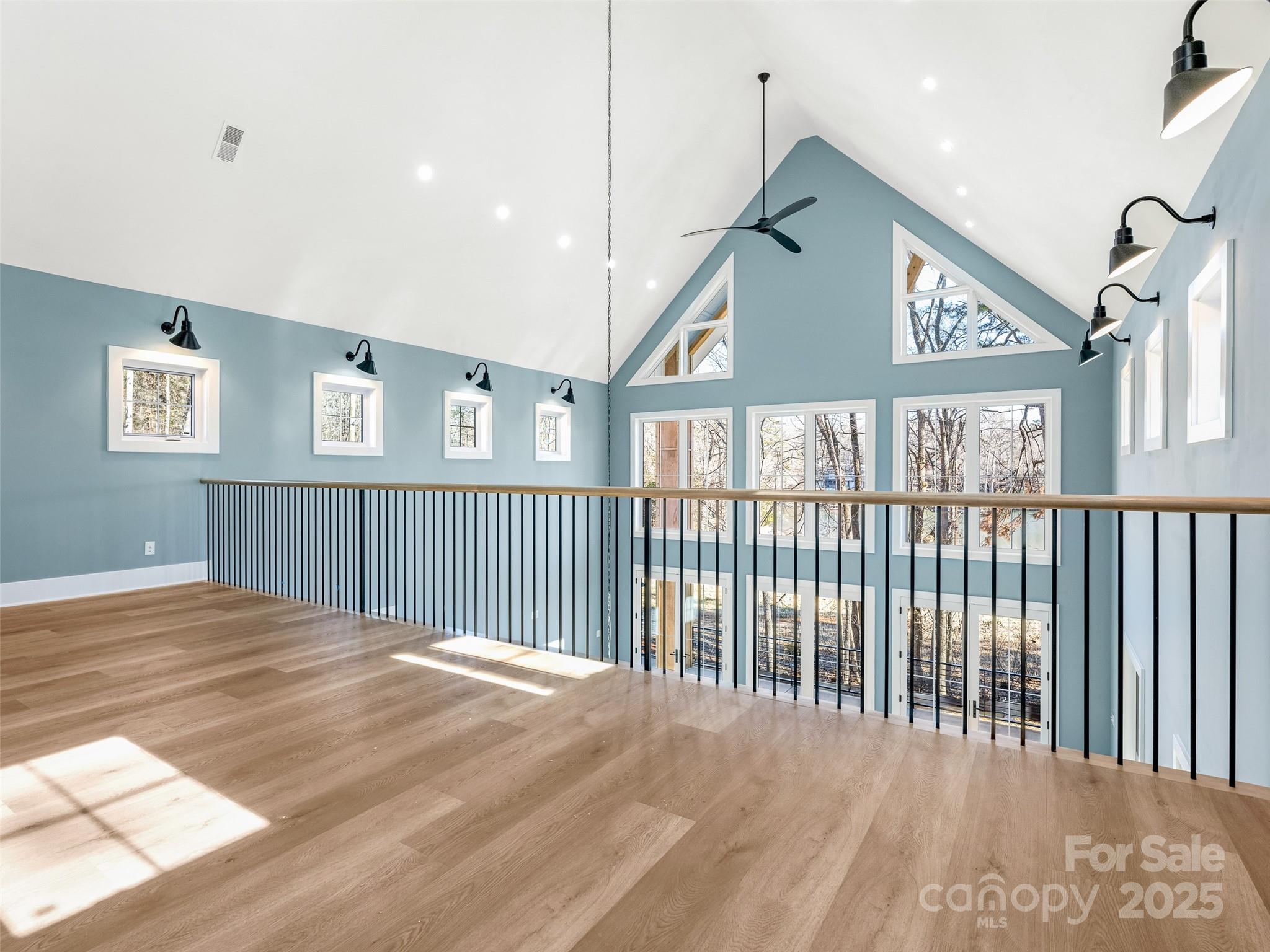597 Evergreen Road Clover, SC 29710 - Photo 10 of 23 a view of a big room with wooden floor and windows