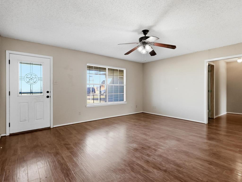 701 College Street Celeste, TX 75423 - Photo 5 of 29 a view of an empty room with wooden floor and a window