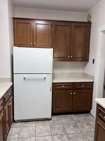 a kitchen with a refrigerator and cabinets