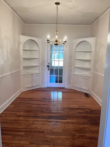 a view of a room with toys and wooden floor