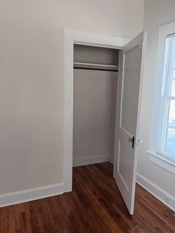 an empty room with wooden floor