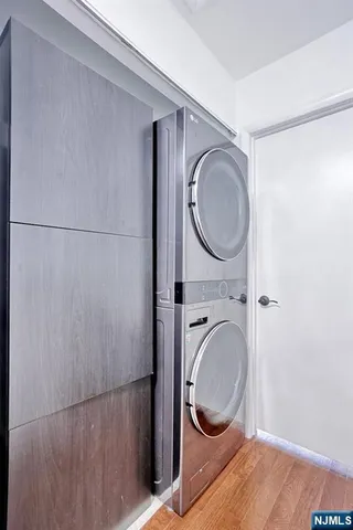 a front view of a building with streets and trees