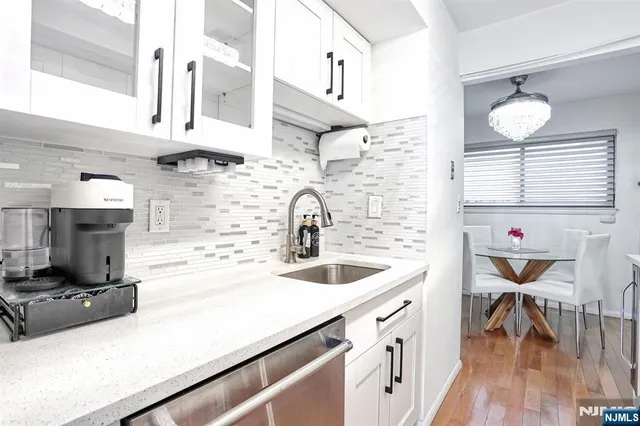 a kitchen with stainless steel appliances granite countertop a stove and a sink