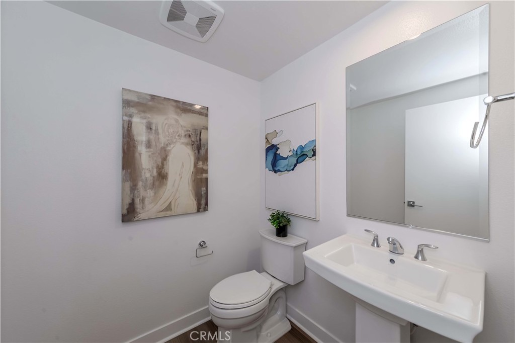 1403 West Bushell Street Anaheim, CA 92805 - Photo 14 of 31 a bathroom with a toilet sink and mirror