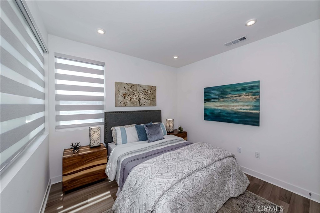 1403 West Bushell Street Anaheim, CA 92805 - Photo 2 of 31 a bedroom with a bed and a painting on the wall