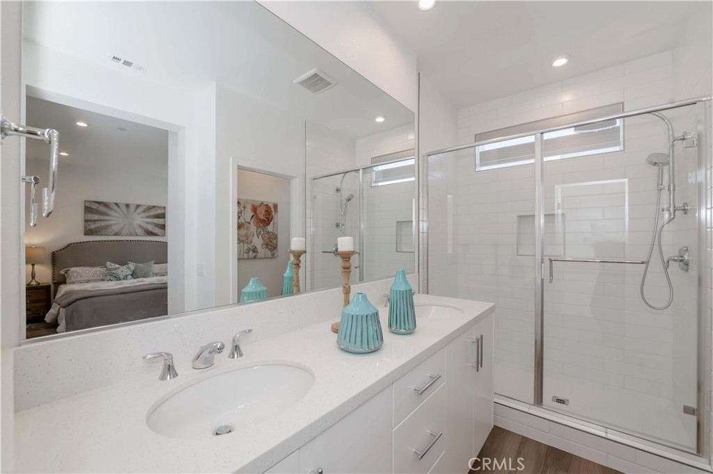1403 West Bushell Street Anaheim, CA 92805 - Photo 26 of 31 a bathroom with a shower sink vanity and mirror