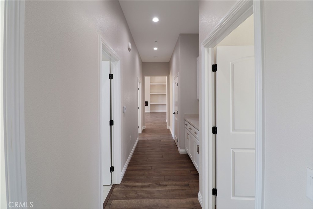 14785 Tigertail Road Apple Valley, CA 92307 - Photo 15 of 20 a view of a hallway with wooden floor and staircase