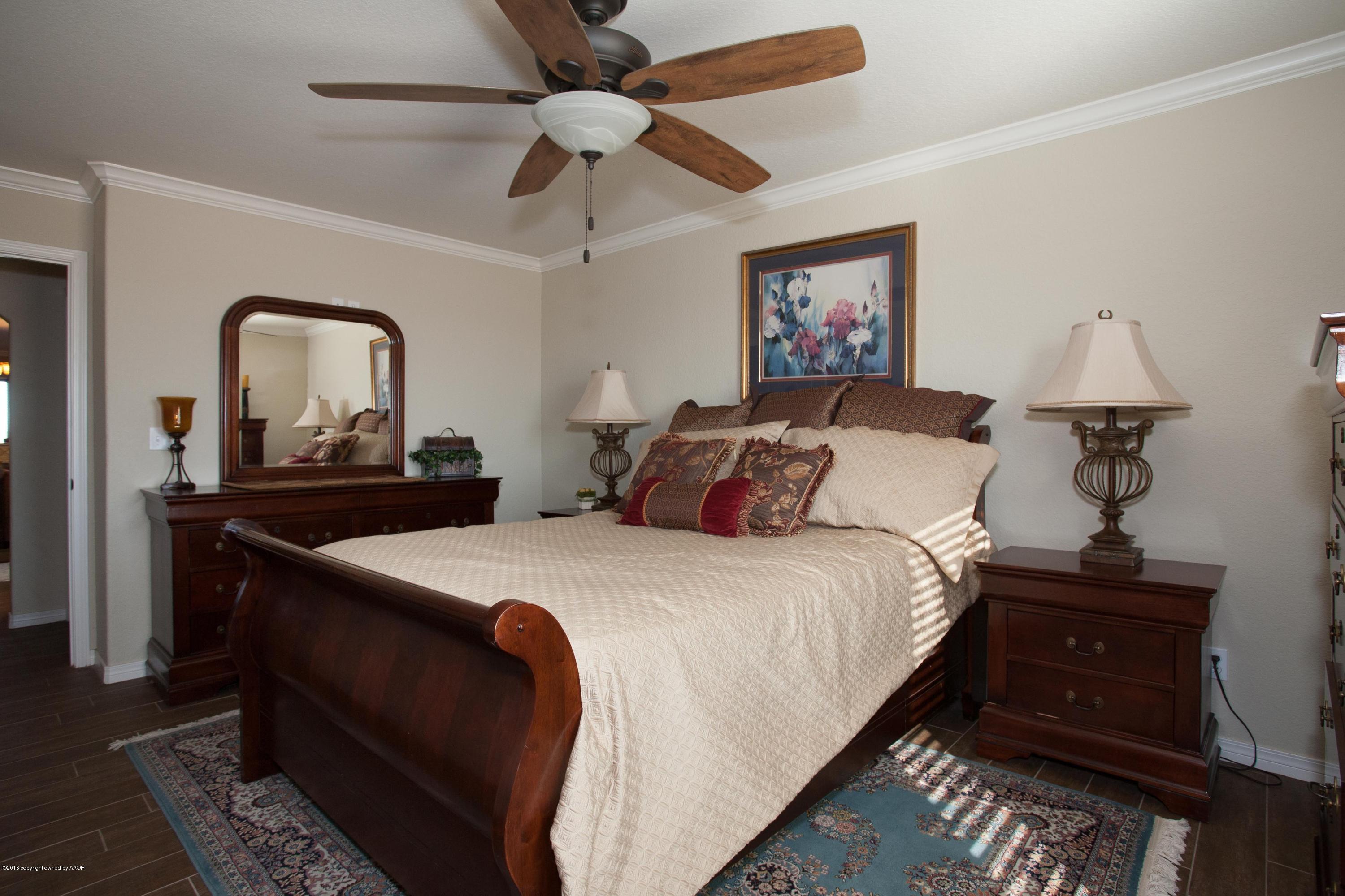 18000 Morning Star Road Bushland, TX 79124 - Photo 14 of 53 a bedroom with bed and a chandelier