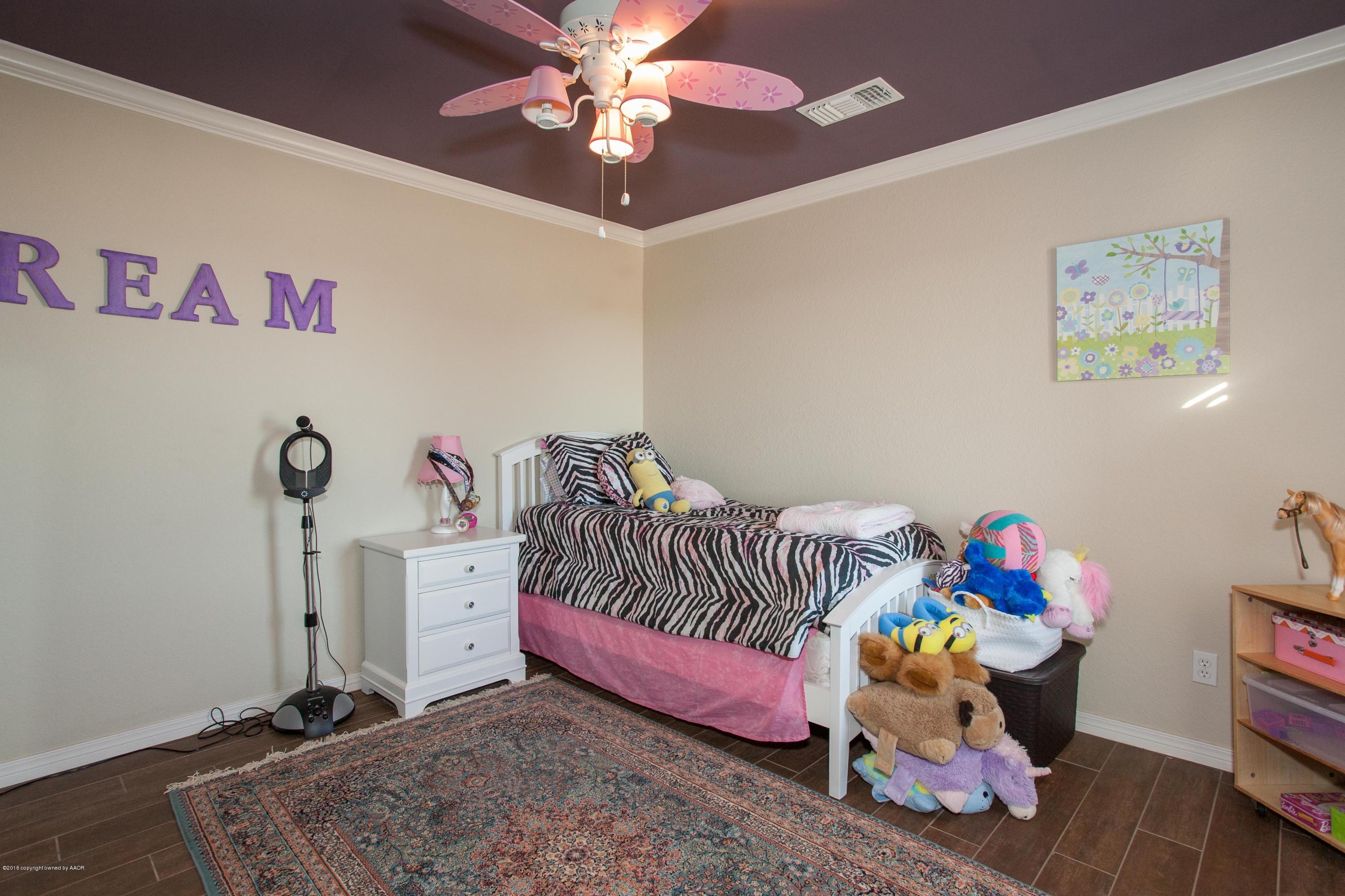 18000 Morning Star Road Bushland, TX 79124 - Photo 21 of 53 a bedroom with a bed and a chandelier