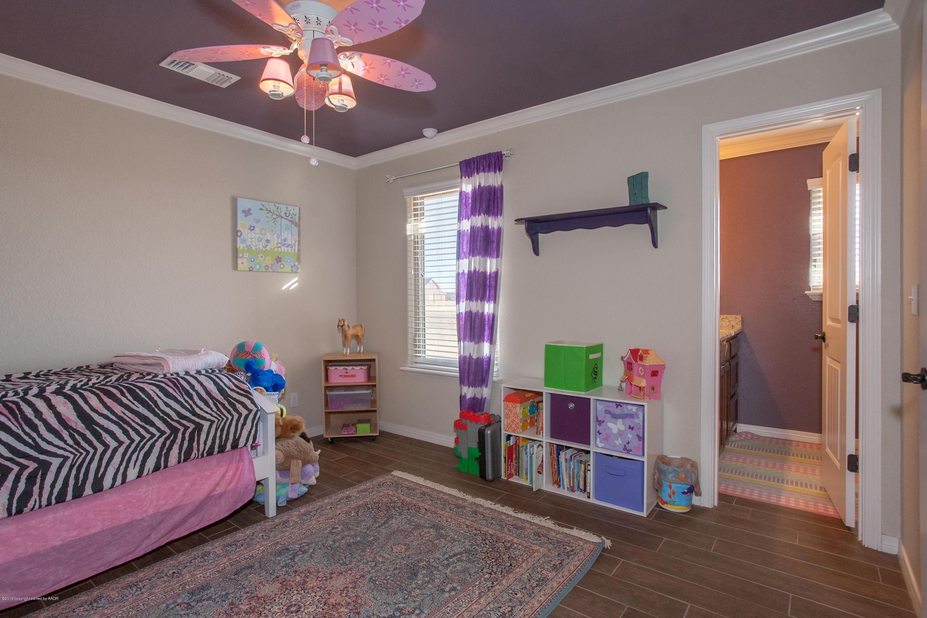 18000 Morning Star Road Bushland, TX 79124 - Photo 22 of 53 a bedroom with a bed and a chandelier