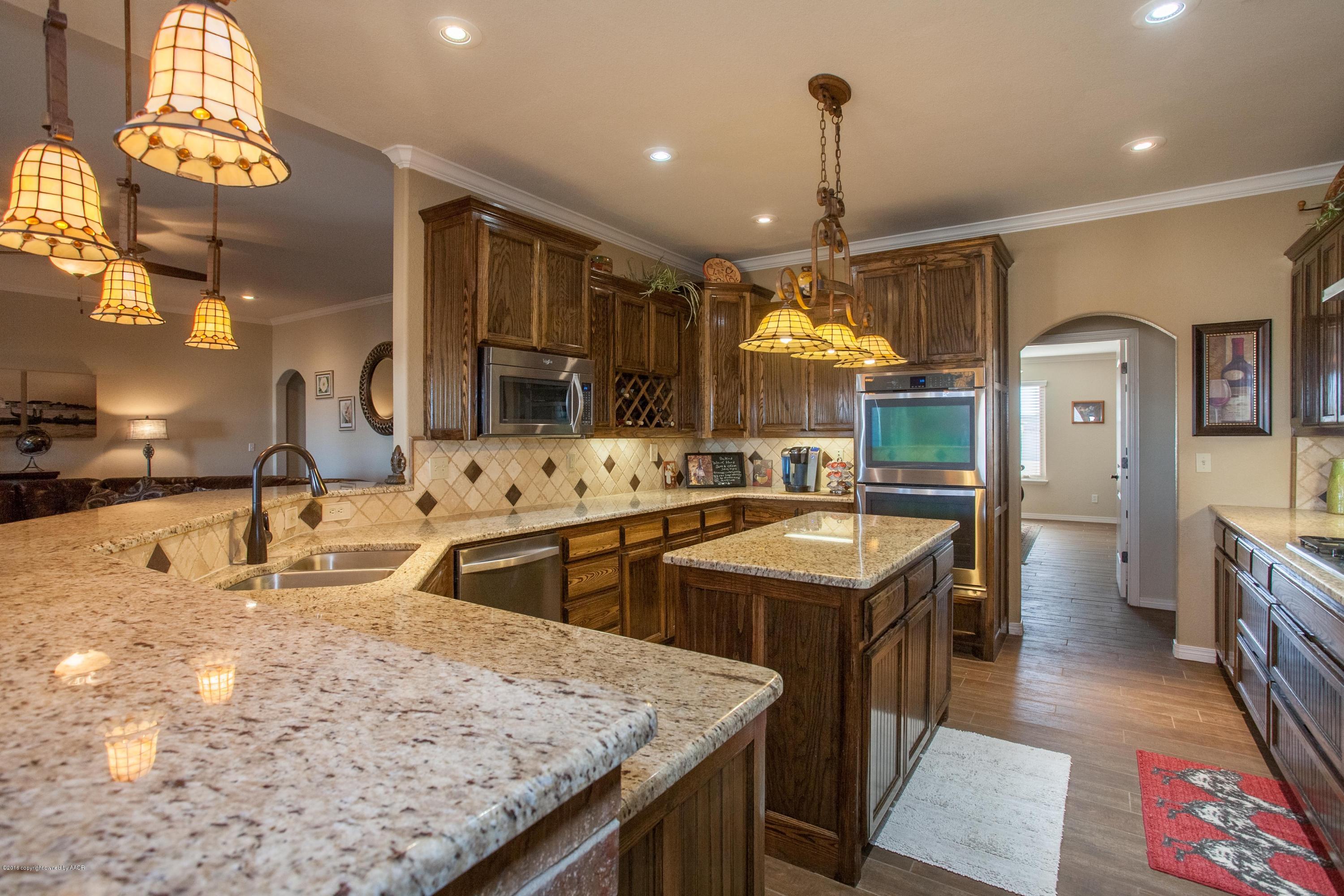 18000 Morning Star Road Bushland, TX 79124 - Photo 7 of 53 a kitchen with stainless steel appliances granite countertop a sink a stove counter space and living room view