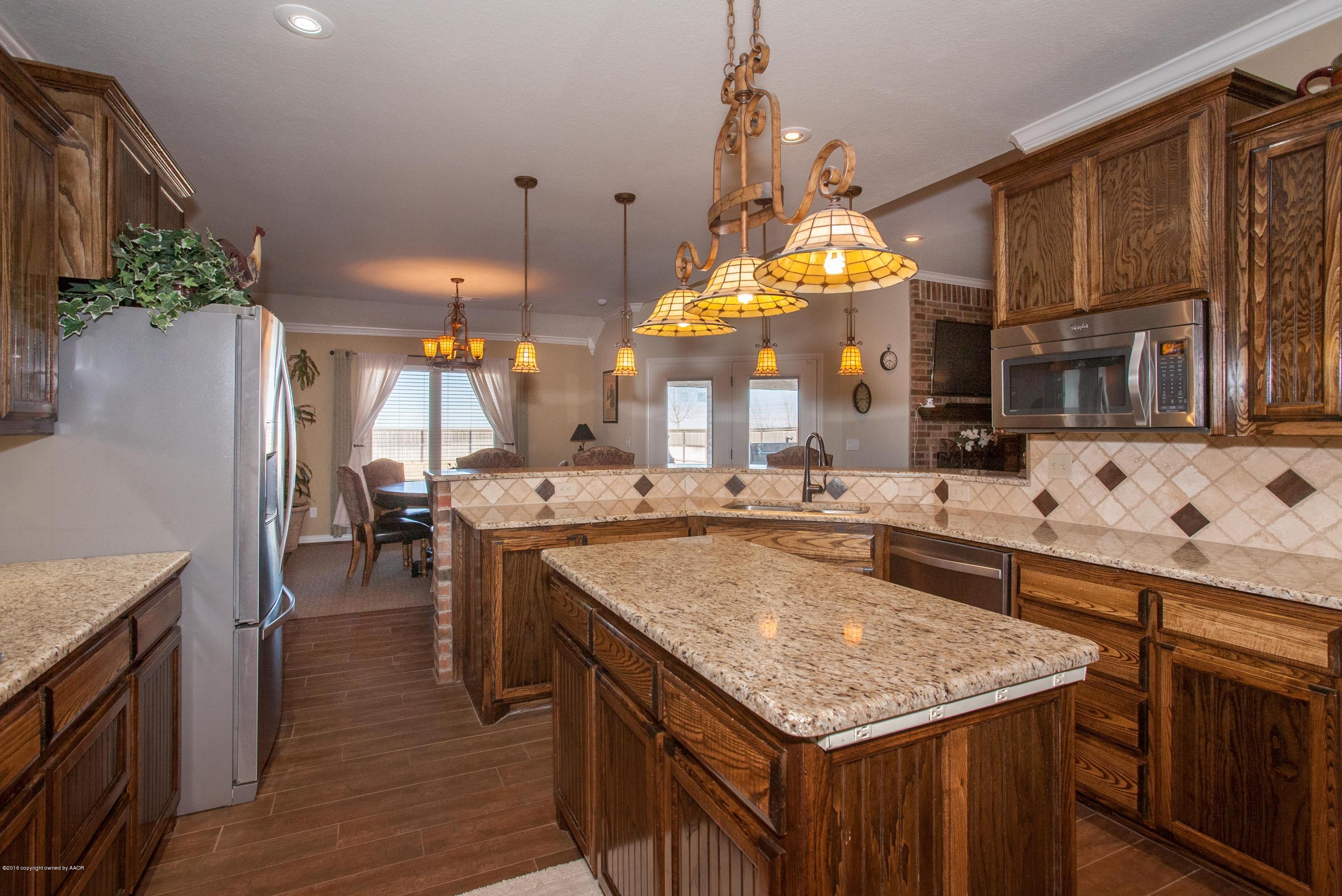 18000 Morning Star Road Bushland, TX 79124 - Photo 8 of 53 a kitchen with stainless steel appliances granite countertop a stove and a sink