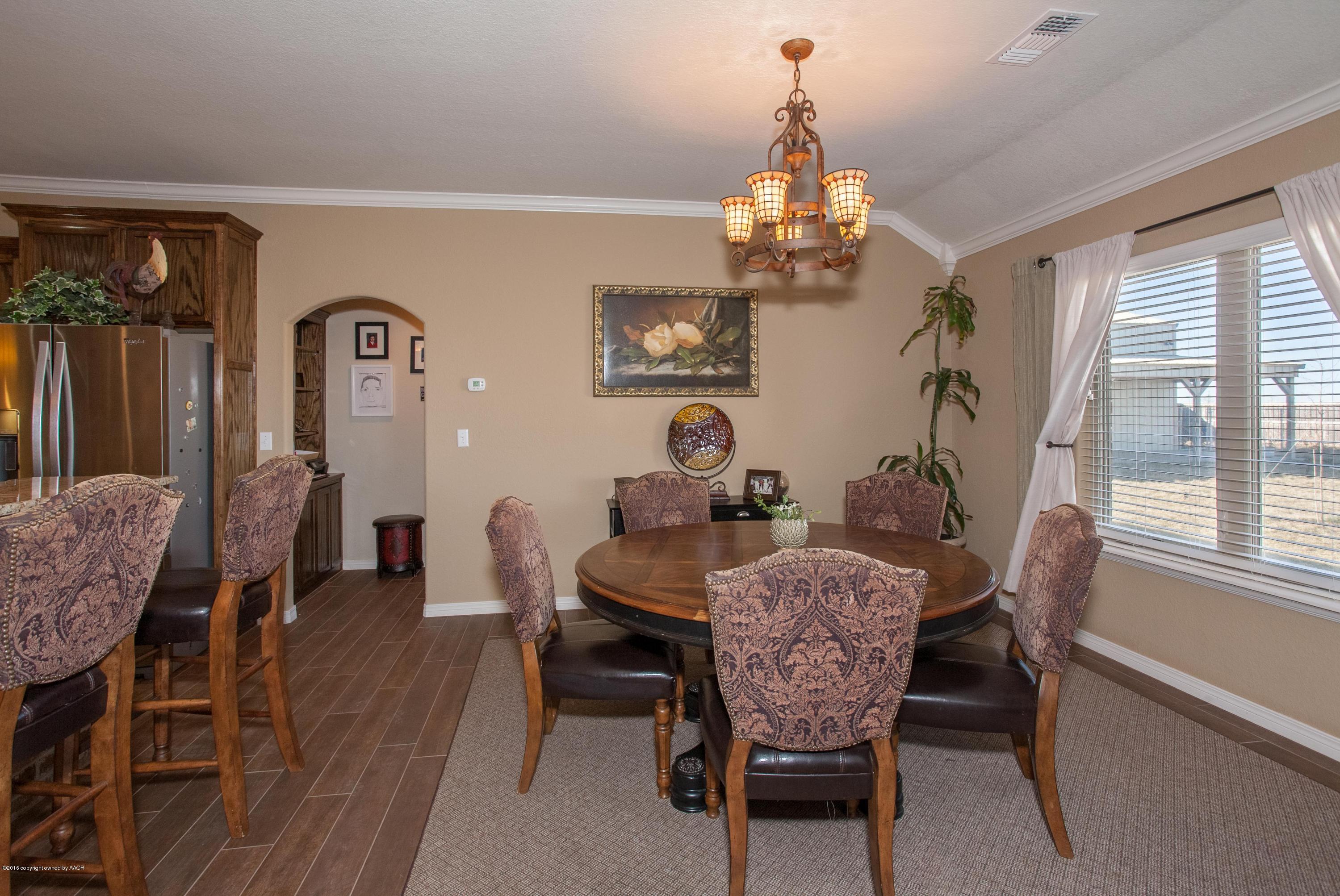 18000 Morning Star Road Bushland, TX 79124 - Photo 10 of 53 a view of a dining room with furniture window and wooden floor