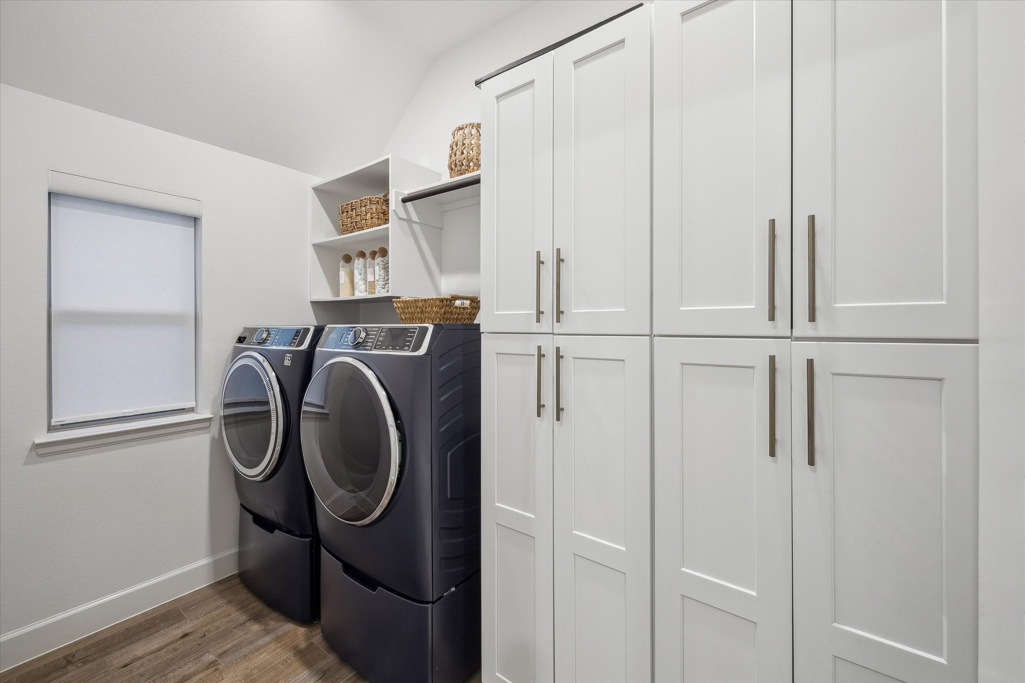 9823 Chapman Trail Manvel, TX 77578 - Photo 15 of 47 Need even more storage? Well here you go! The laundry room boasts built-in cabinetry and comes complete with a front loading washer and dryer each on a pedestal base.