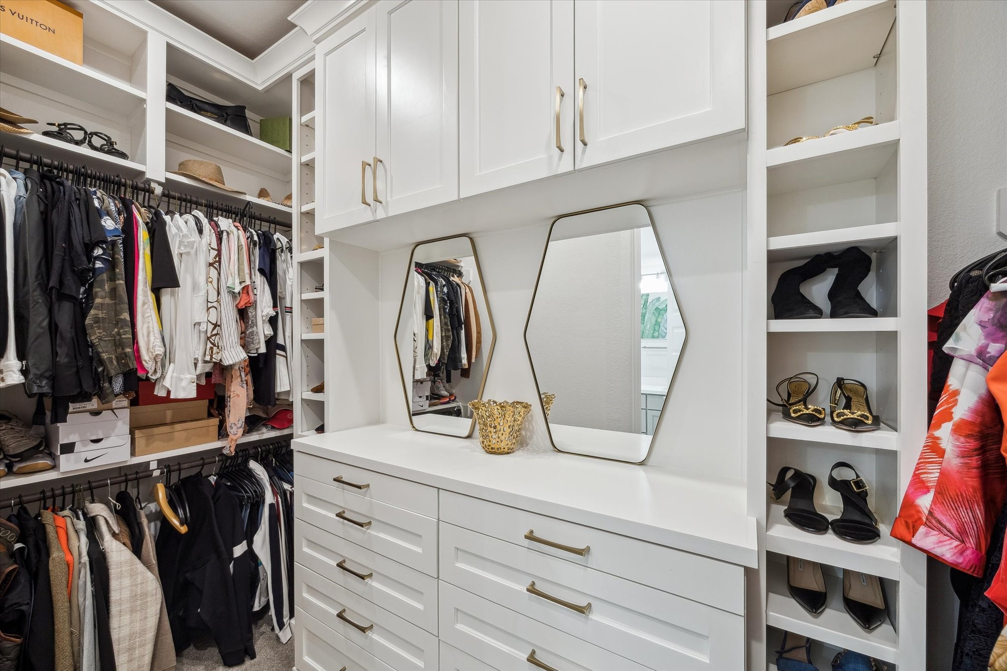 9823 Chapman Trail Manvel, TX 77578 - Photo 22 of 47 The primary closet has been fully customized and it's a showstopper! Smartly organized, all the way to the ceiling, there's a place for everything here.