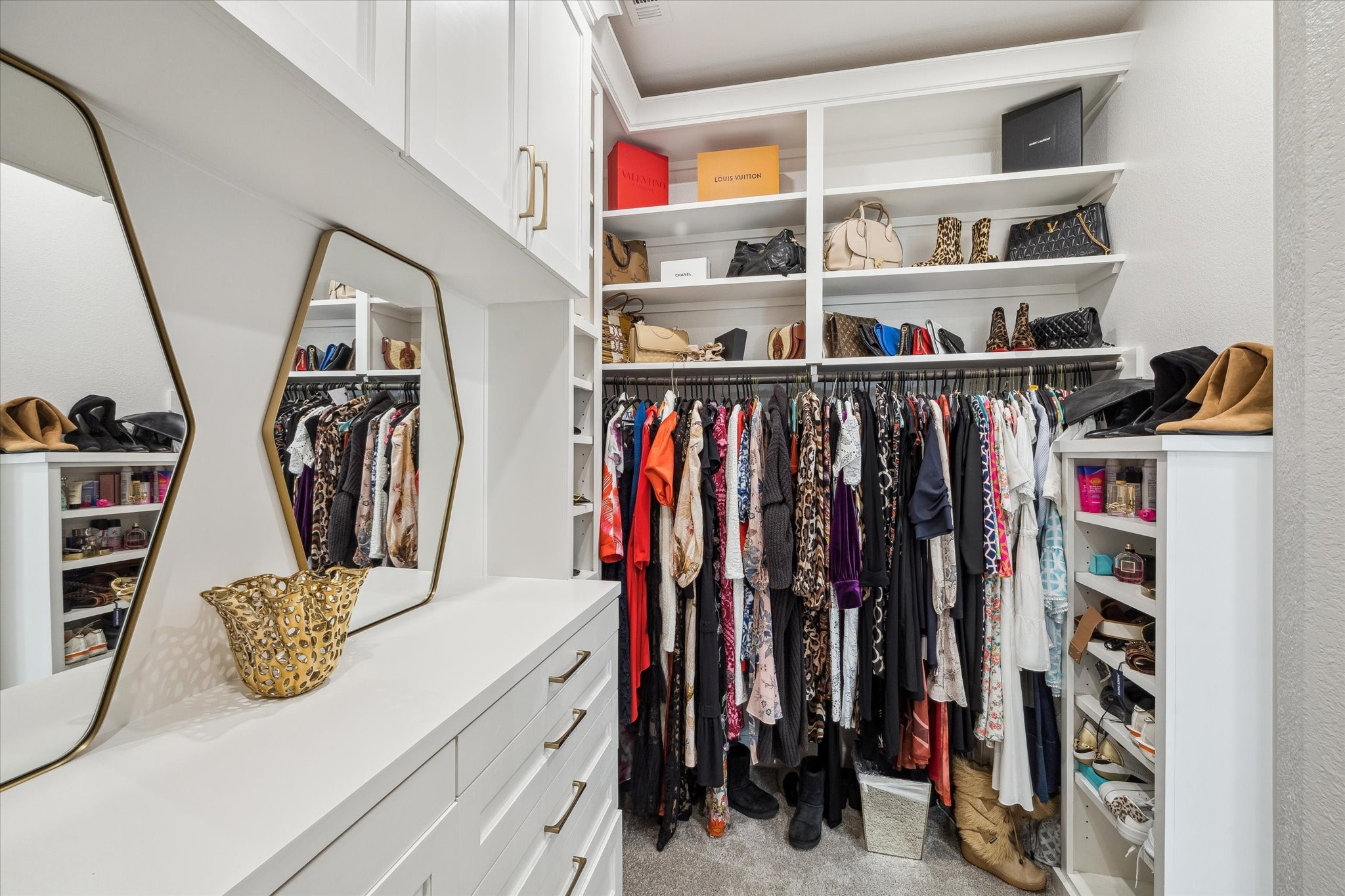 9823 Chapman Trail Manvel, TX 77578 - Photo 23 of 47 In addition to the drawers and cabinetry, there is ample hanging space on either side of the room. Elegant mirrors and modern fixtures add a touch of luxury.