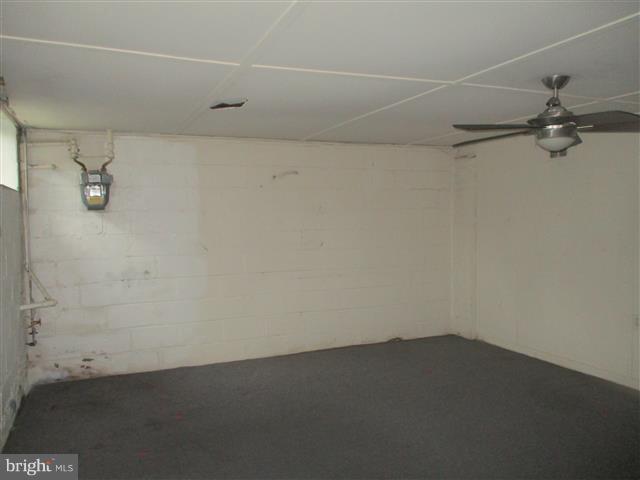 2707 Edison Highway Baltimore, MD 21213 - Photo 20 of 25 an empty room with a ceiling fan and carpet