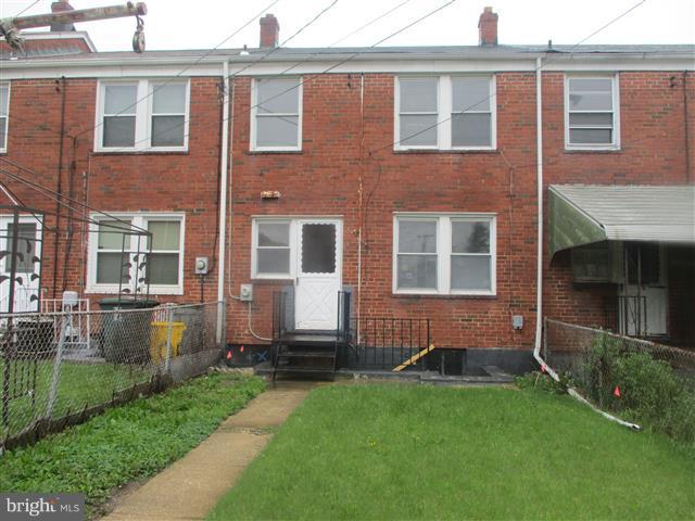 2707 Edison Highway Baltimore, MD 21213 - Photo 23 of 25 a backyard of a house with barbeque oven and garden
