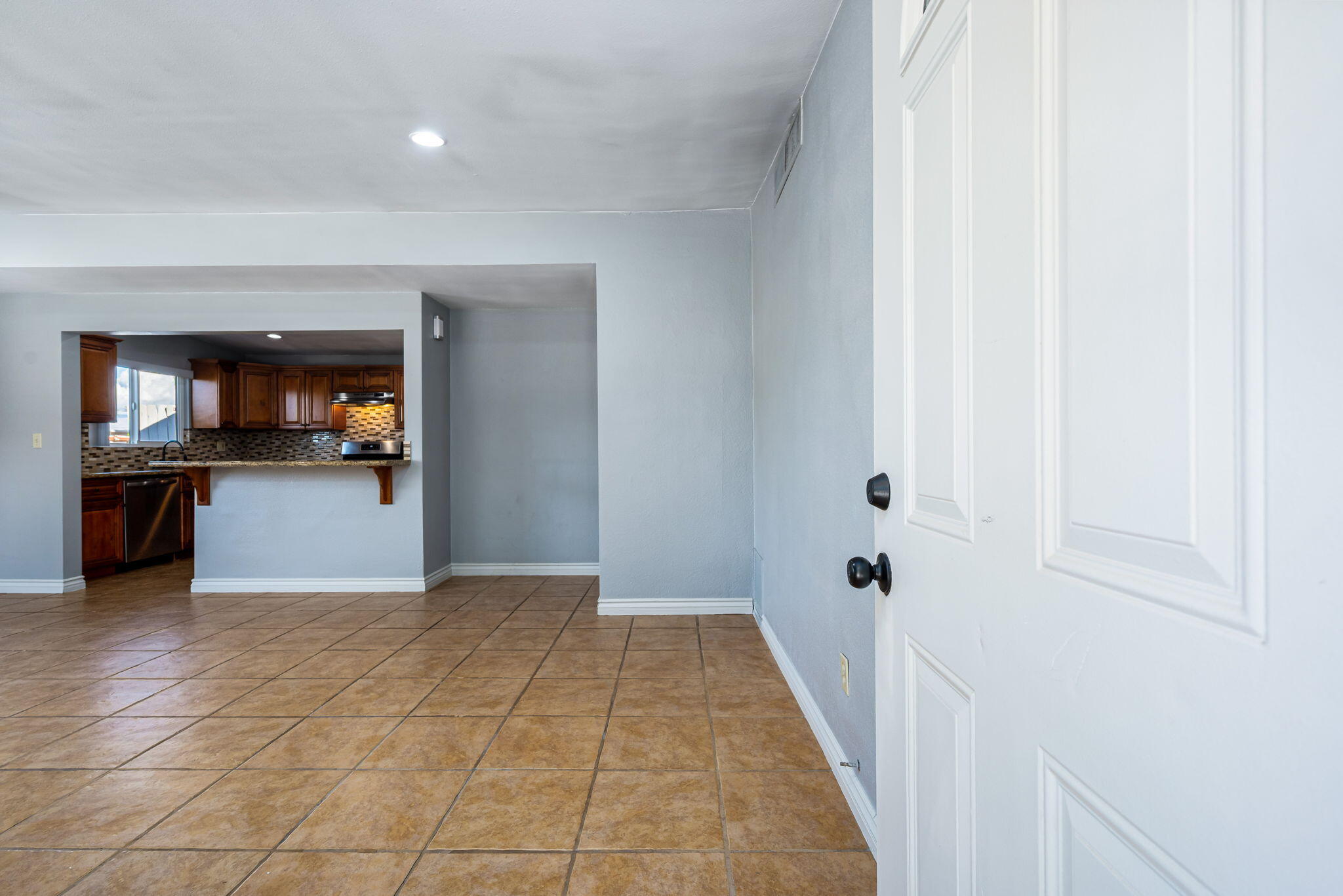 73333 Santa Rosa Way Palm Desert, CA 92260 - Photo 15 of 37 a view of a hallway with wooden floor and a kitchen