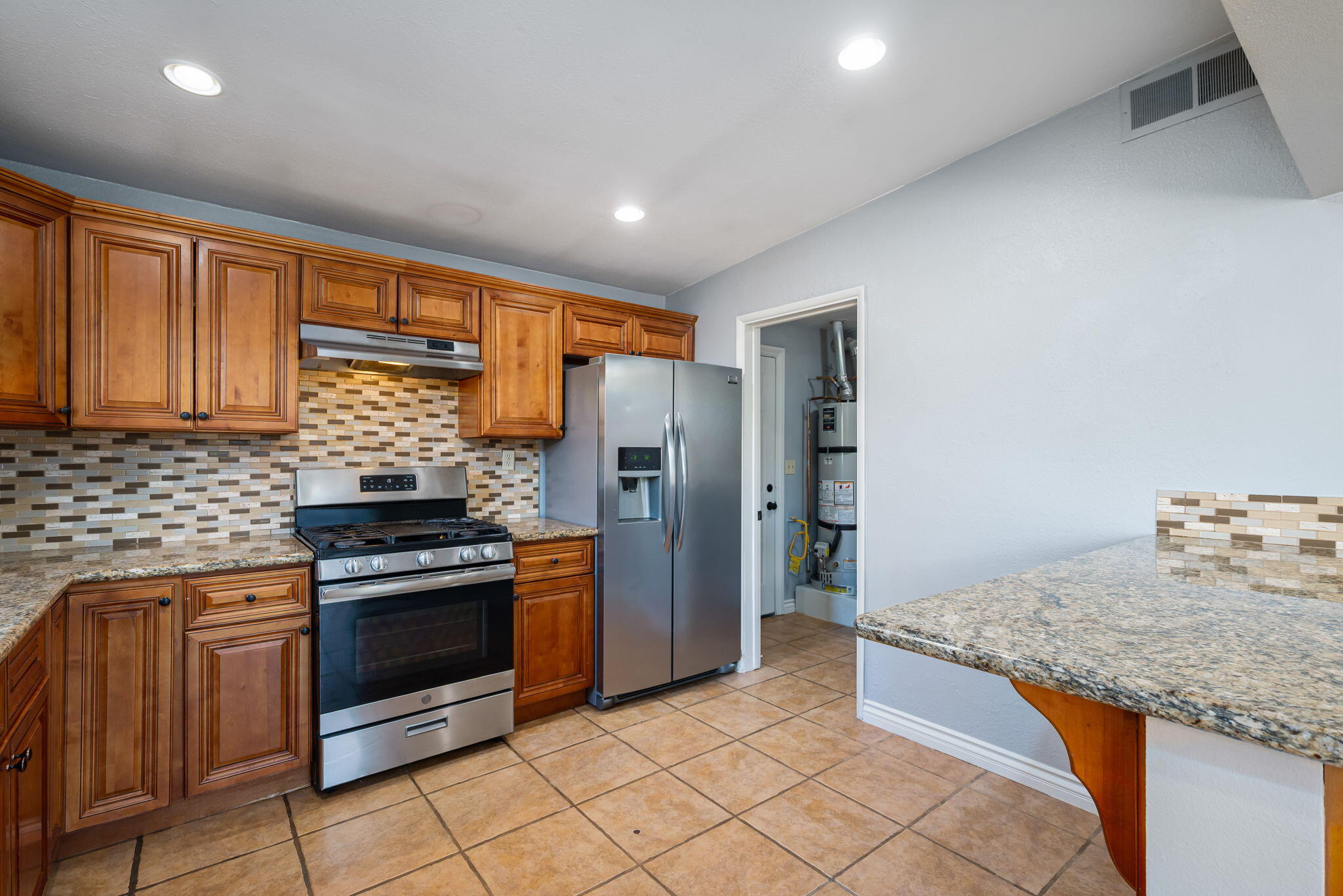73333 Santa Rosa Way Palm Desert, CA 92260 - Photo 23 of 37 a kitchen with stainless steel appliances granite countertop a stove a sink and a refrigerator