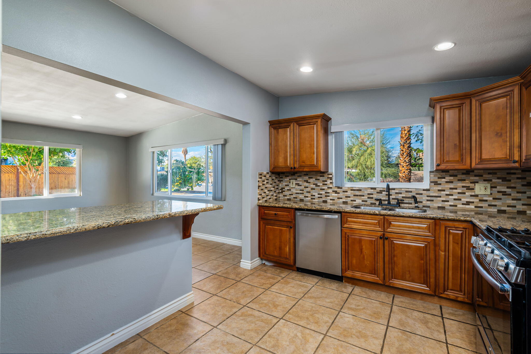 73333 Santa Rosa Way Palm Desert, CA 92260 - Photo 27 of 37 a kitchen with granite countertop a sink window and cabinets