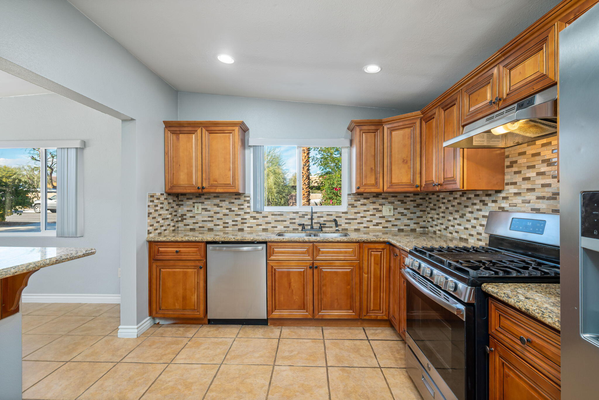 73333 Santa Rosa Way Palm Desert, CA 92260 - Photo 28 of 37 a kitchen with stainless steel appliances granite countertop a sink stove and cabinets