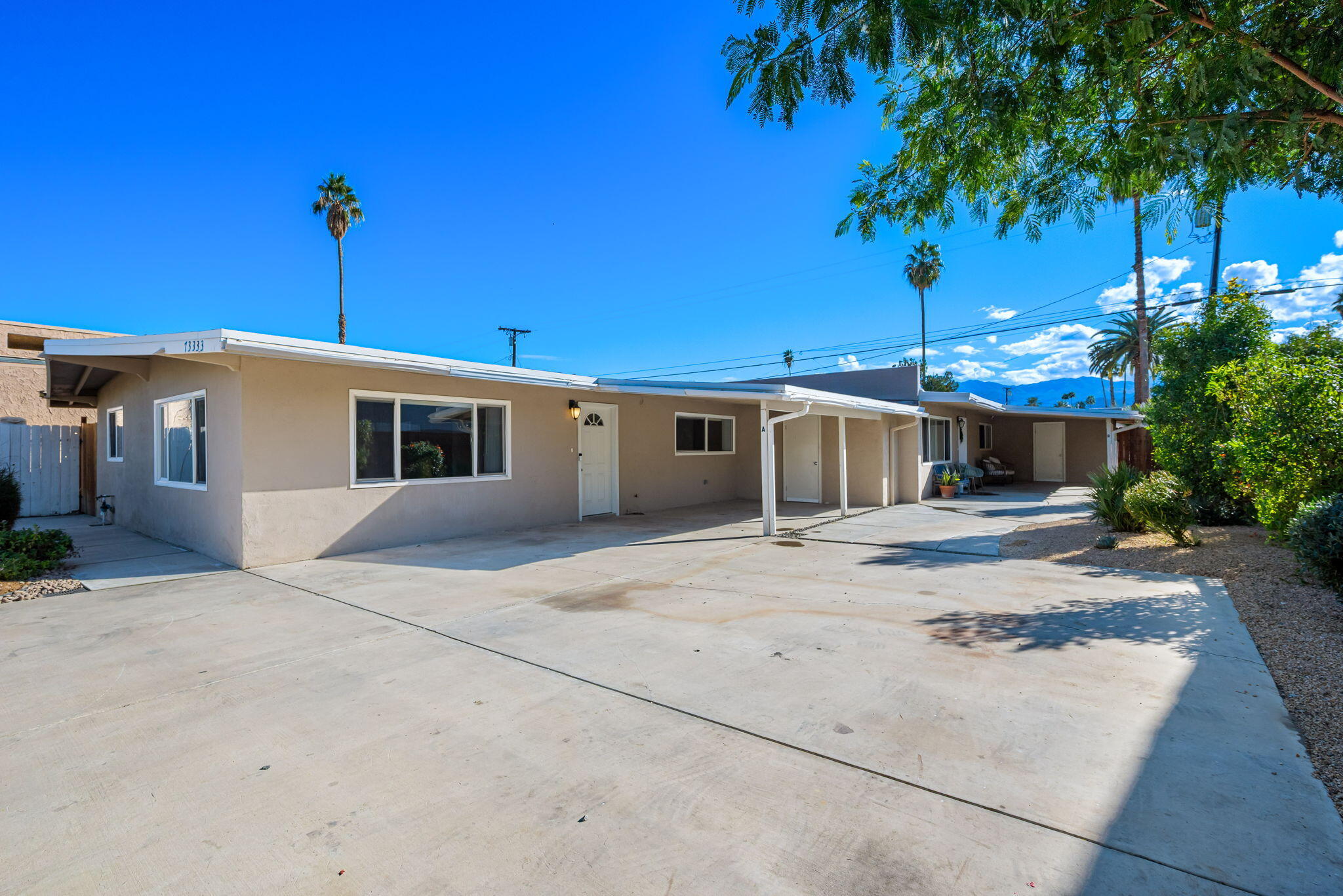 73333 Santa Rosa Way Palm Desert, CA 92260 - Photo 3 of 37 a front view of a house with a yard and a garage