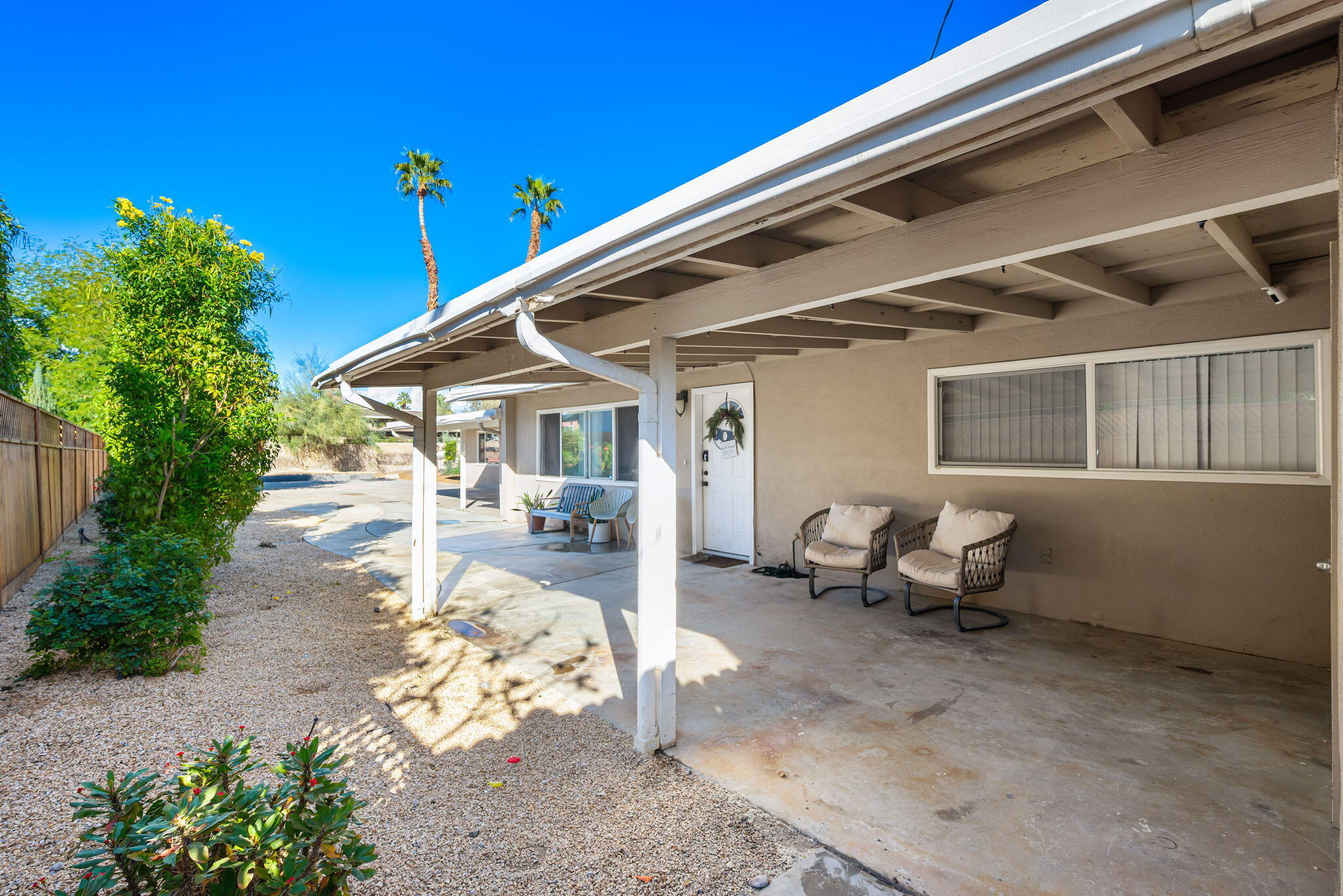 73333 Santa Rosa Way Palm Desert, CA 92260 - Photo 7 of 37 a view of a patio with table and chairs and potted plants