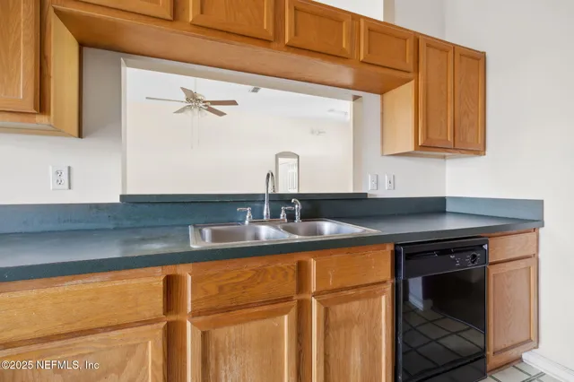 a spacious bedroom with a large bed and a chandelier fan