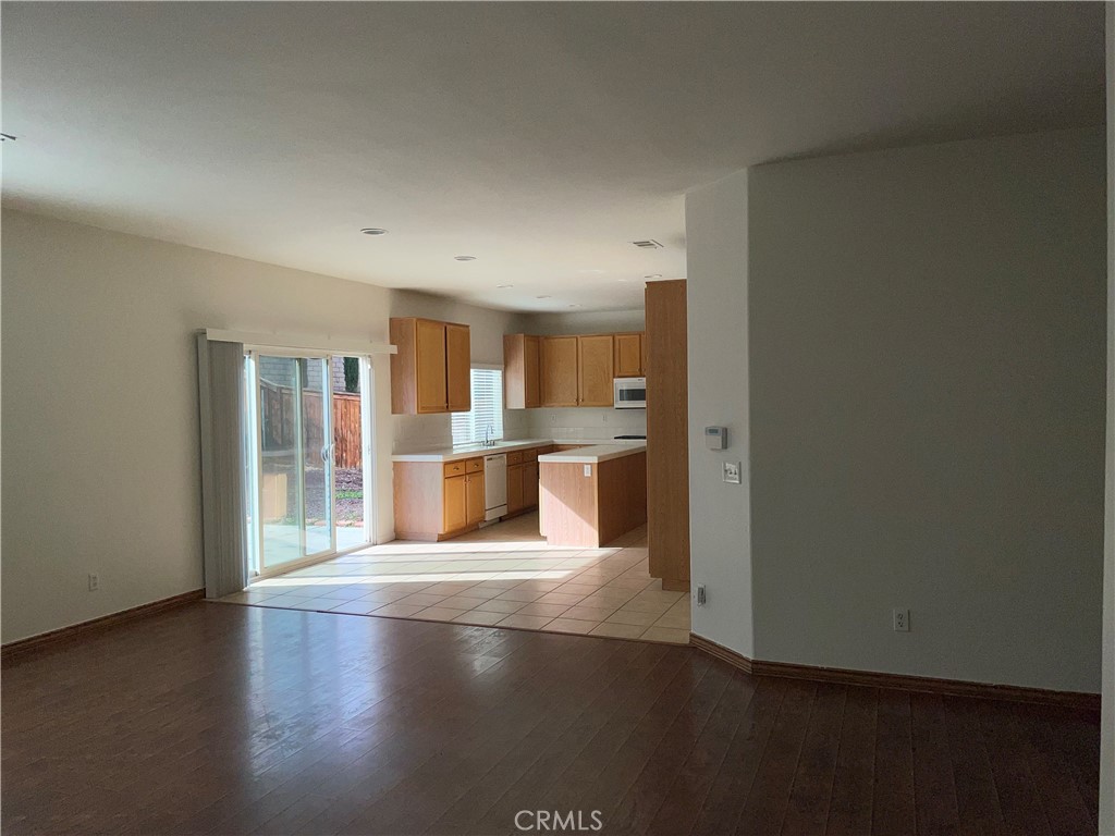 12661 Luna Road Victorville, CA 92392 - Photo 6 of 20 a view of a kitchen with wooden floor and a kitchen
