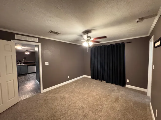 a view of a livingroom with a chandelier fan and closet area