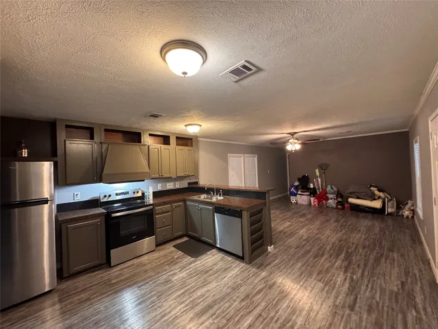 a kitchen with kitchen island a stove and a refrigerator