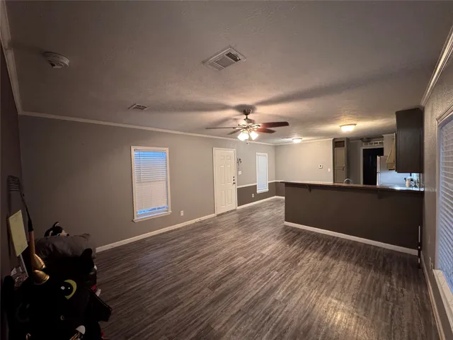 a kitchen with a refrigerator and a stove top oven