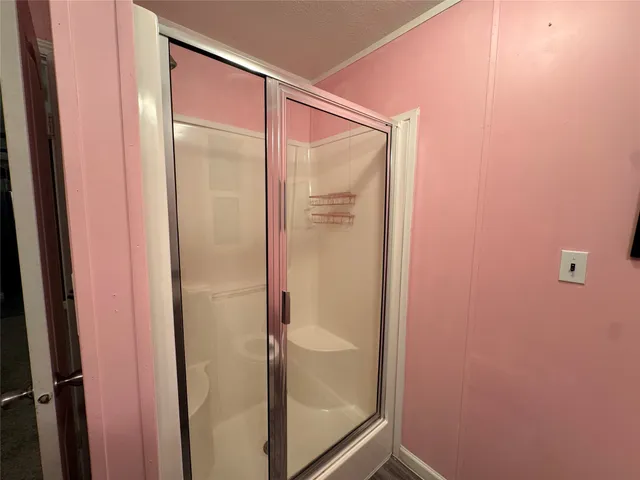 a bathroom with a glass shower door