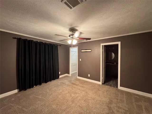 a view of a livingroom with a chandelier fan and closet area