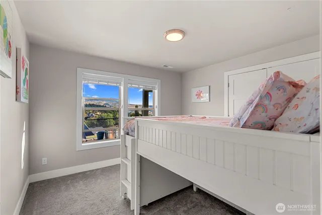 a bathroom with a granite countertop sink a toilet and a mirror