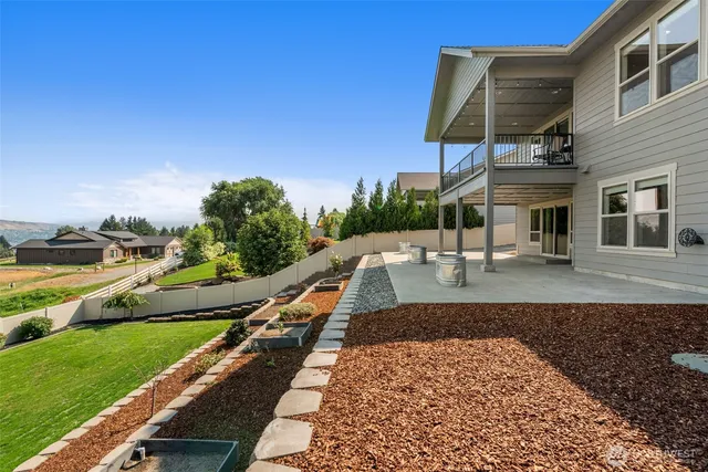 a view of a patio with dining table and chairs