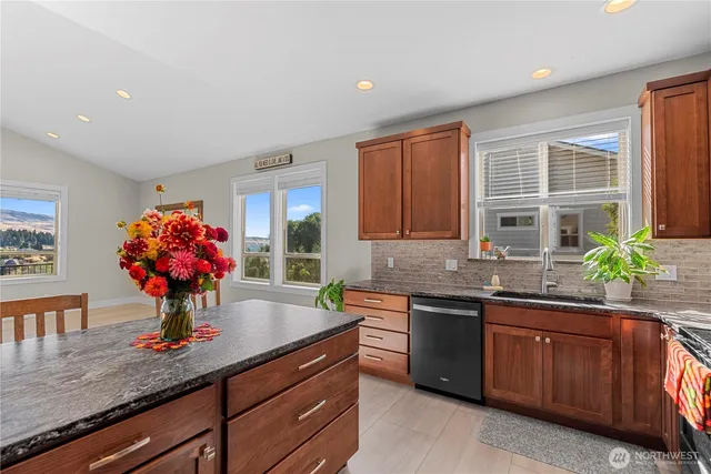 a kitchen with stainless steel appliances granite countertop a sink and cabinets