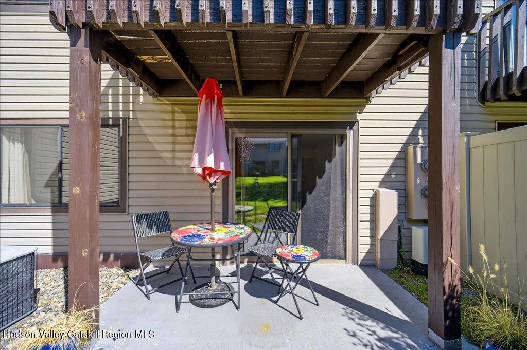 6 Knights Bridge, Unit B Poughkeepsie, NY 12603 - Photo 12 of 20 a patio with table and chairs and potted plants